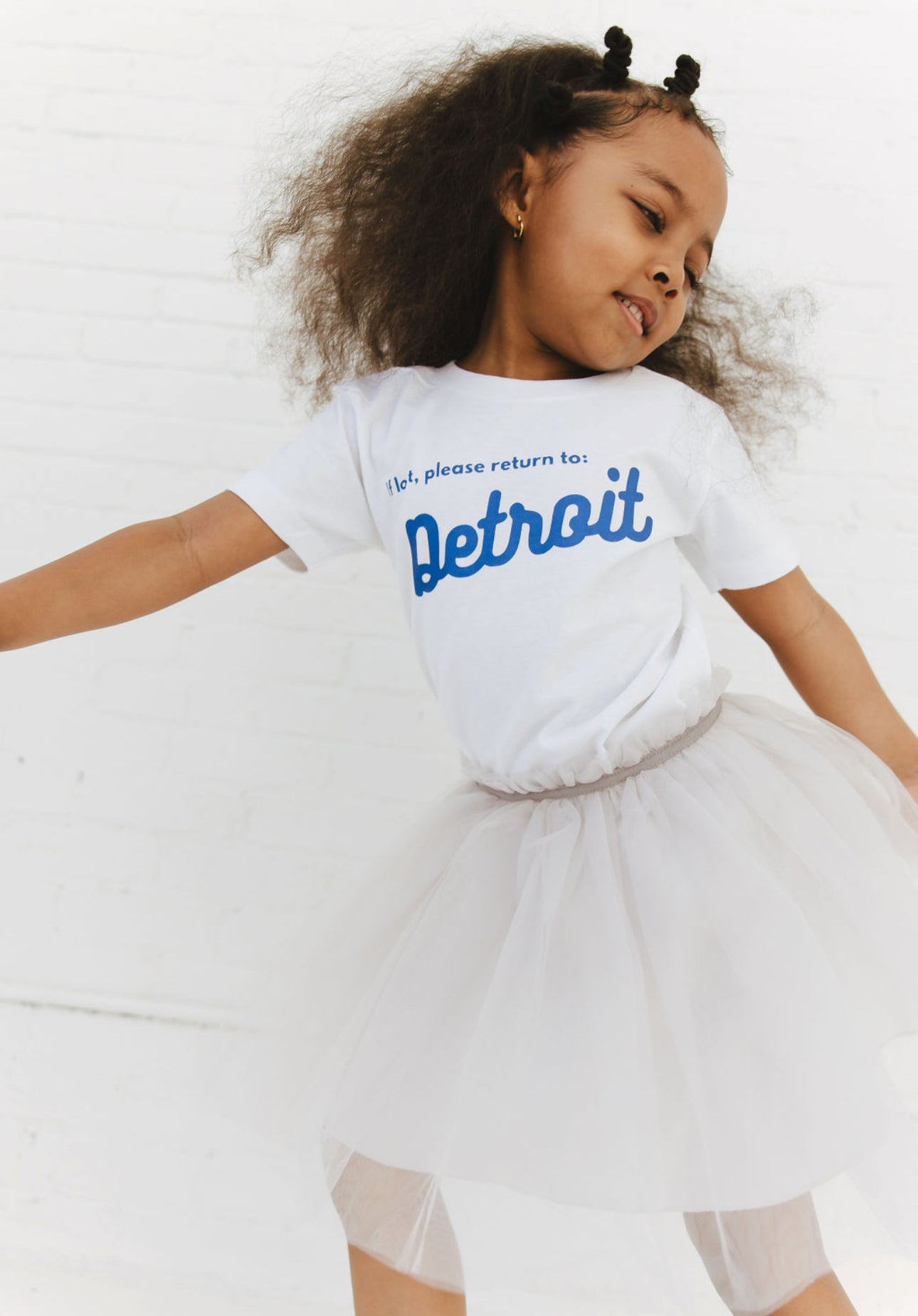 Girl wearing white Detroit Tee