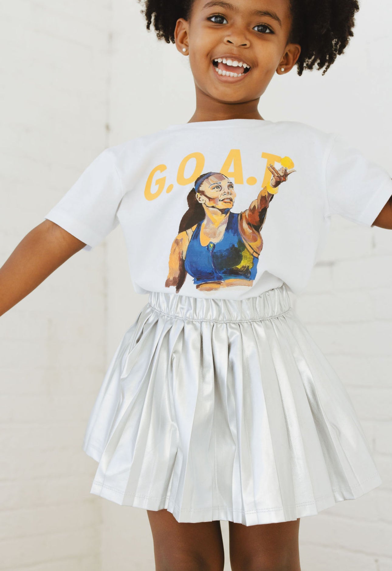 Child wearing GOAT Serena Tee Standing
