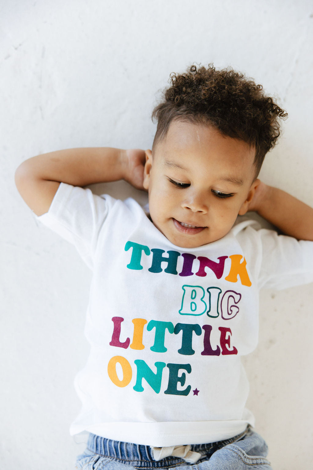 Child wearing a Think Big Little One White tee