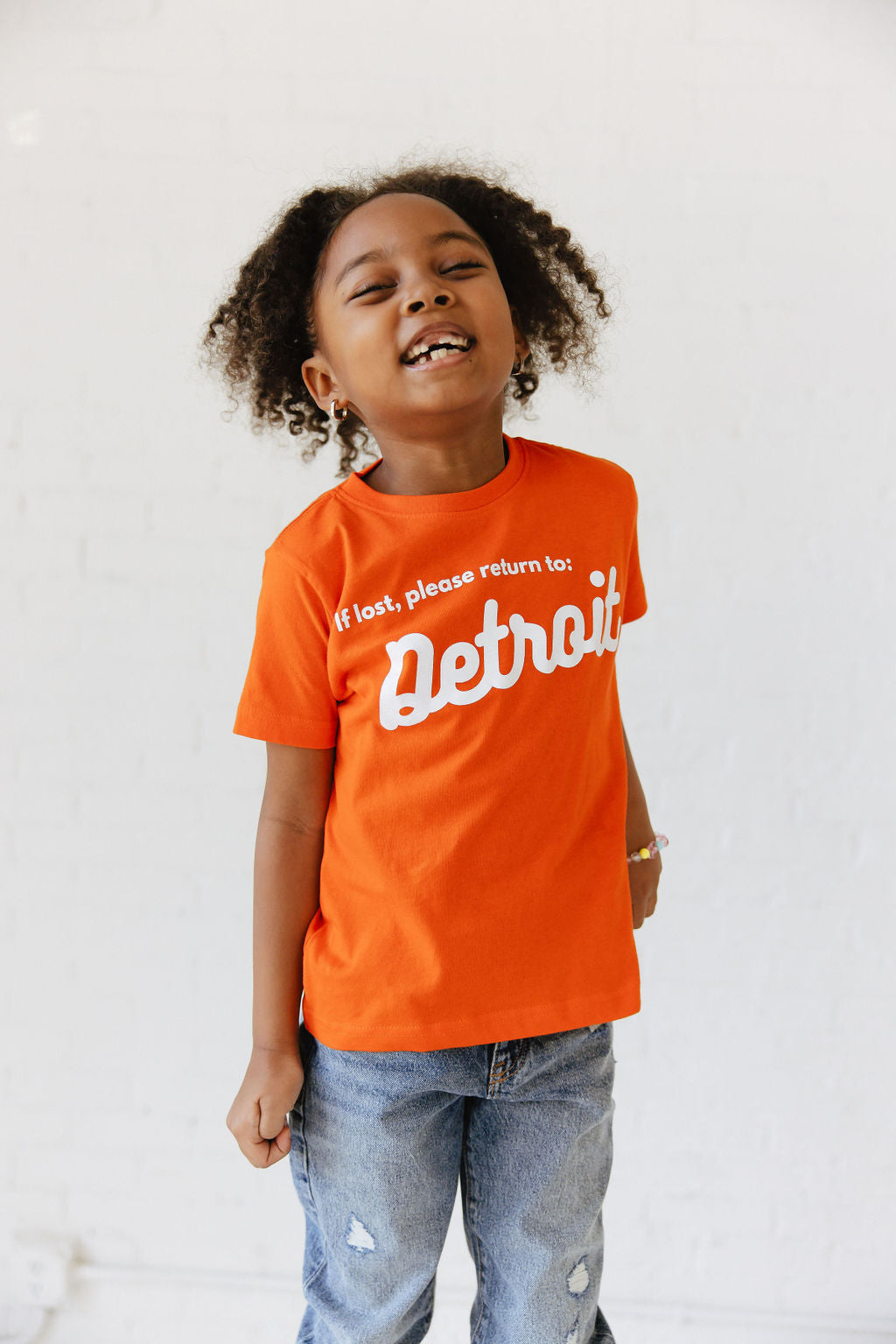 Girl wearing Orange Detroit Tee
