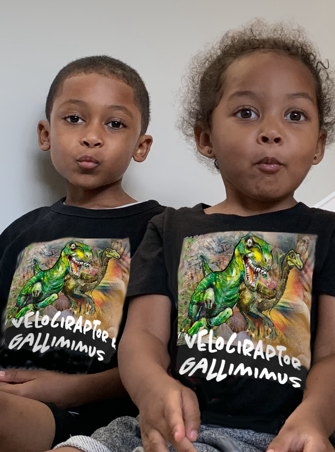 Two children wearing dinosaur tee shirts