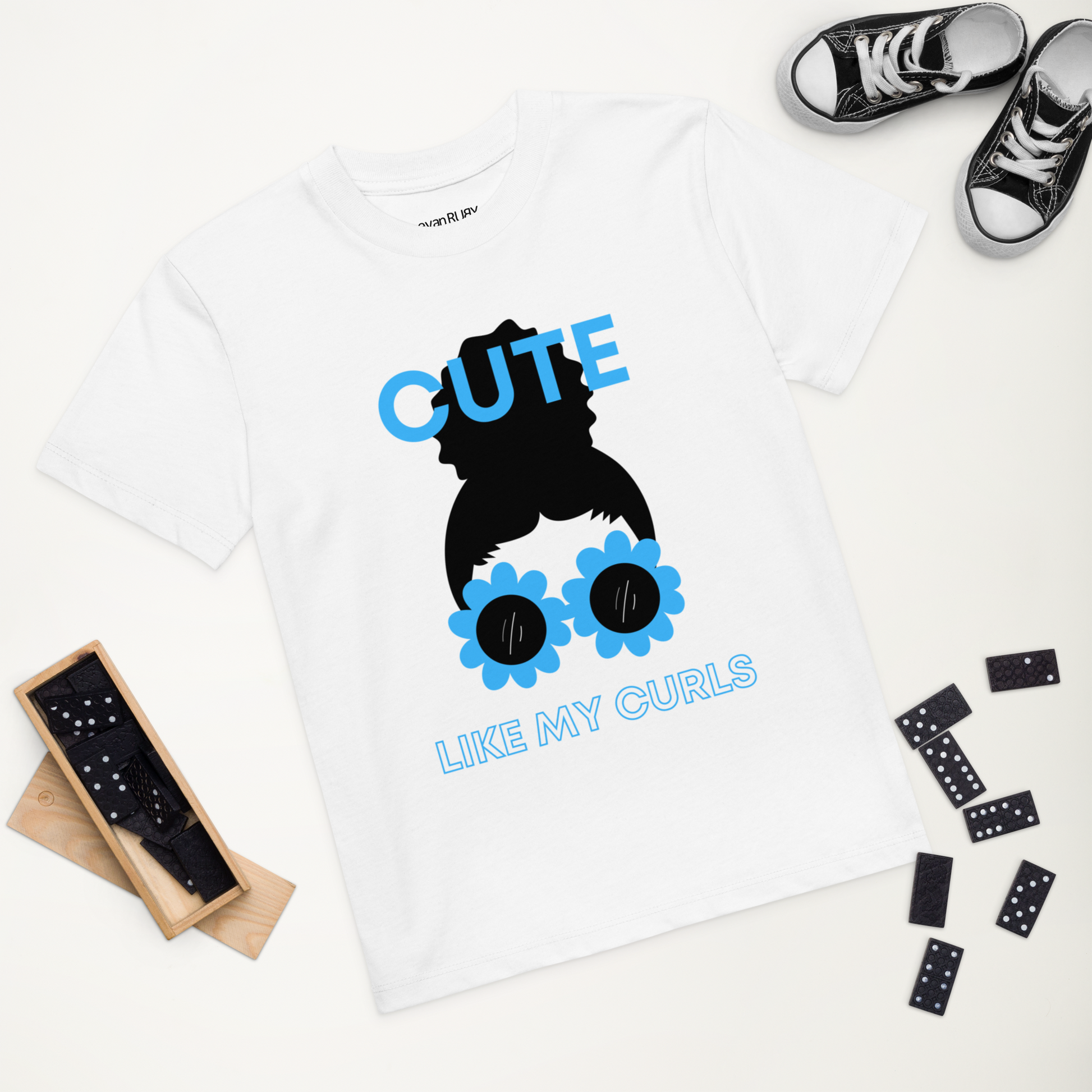 A white t-shirt with a graphic print of a character resembling a girl with curly hair and sunglasses.