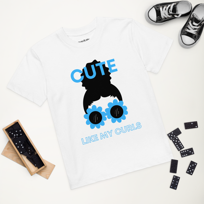 A white t-shirt with a graphic print of a character resembling a girl with curly hair and sunglasses.