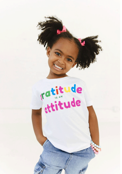 Child wearing white Gratitude Tee