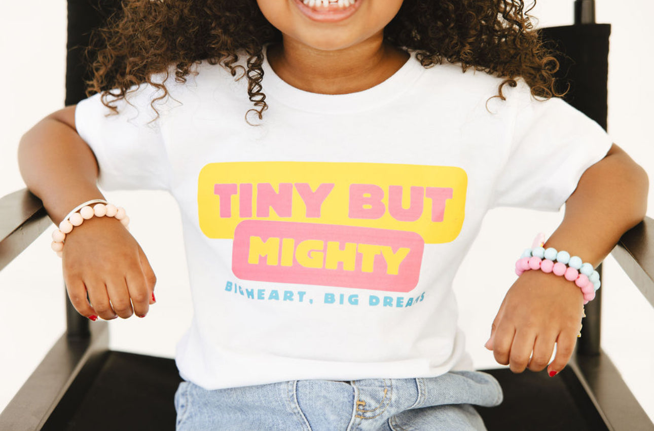 Child Wearing White Tiny but Mighty Tee