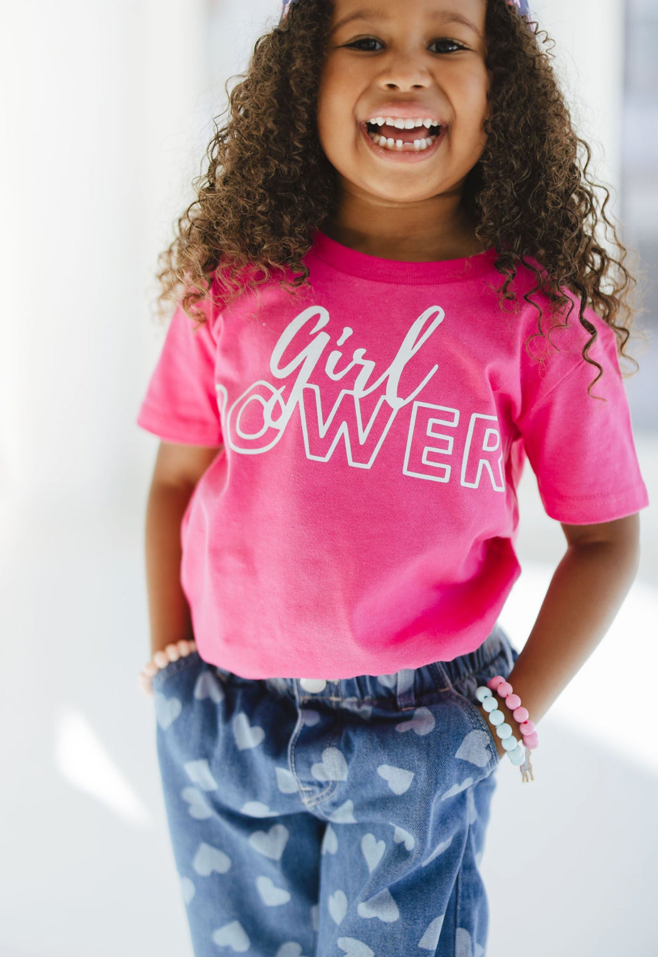 Girl wearing Heliconia Girl Power Tee White Lettering