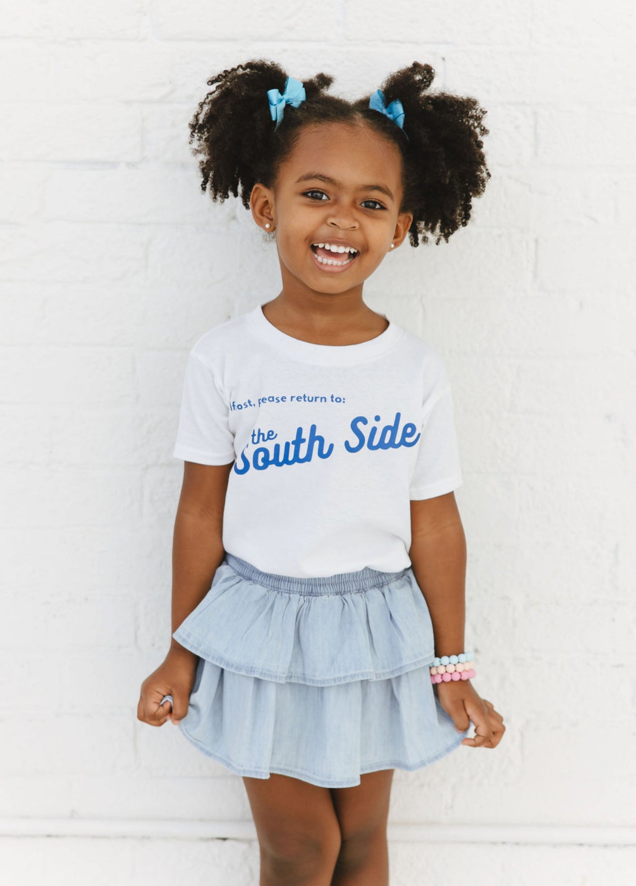 CHILD WEARING BLUE LETTERING SOUTH SIDE TEE