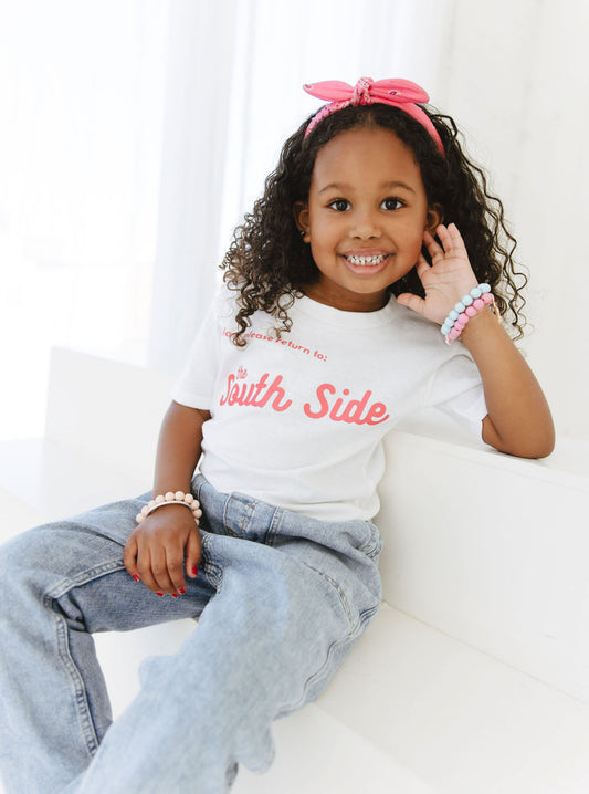 CHILD WEARING PINK LETTERING SOUTH SIDE TEE