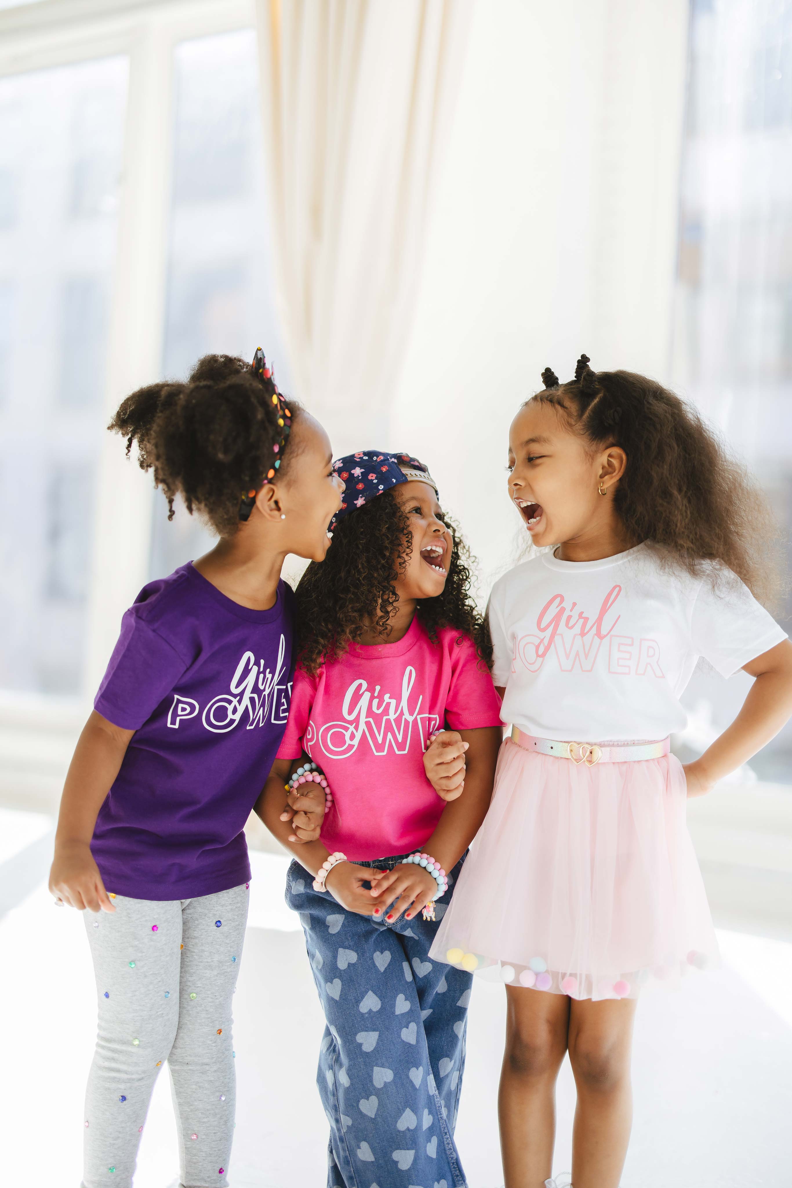 Three girls wearing EvanRuby Girl Power Tees