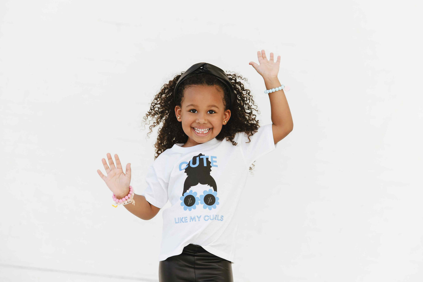 Child wearing Cute Curls White Tee Blue and Black graphic