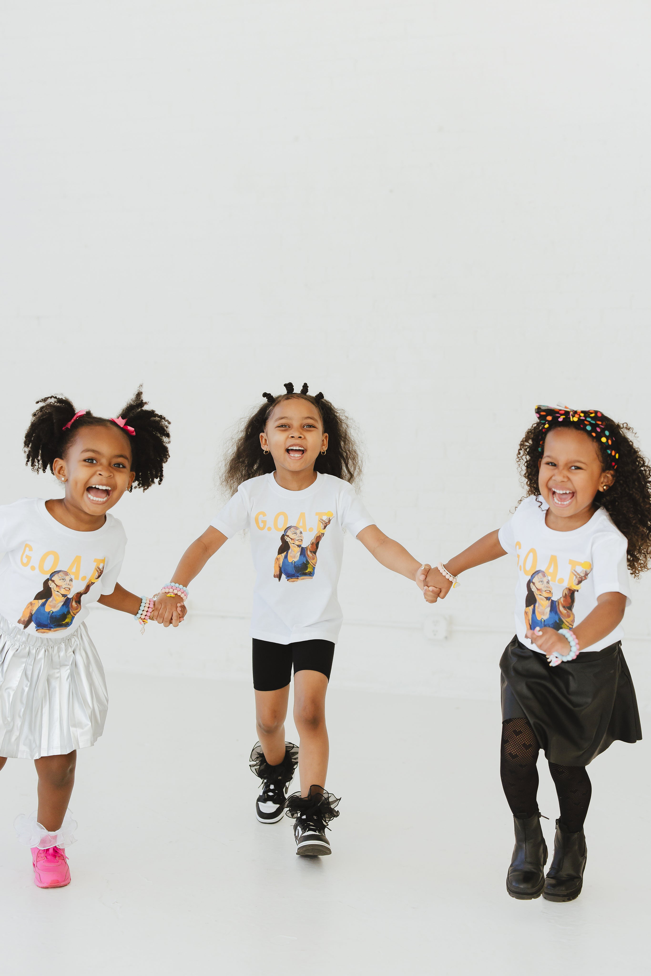 Three Girls Playing wearing GOAT tees